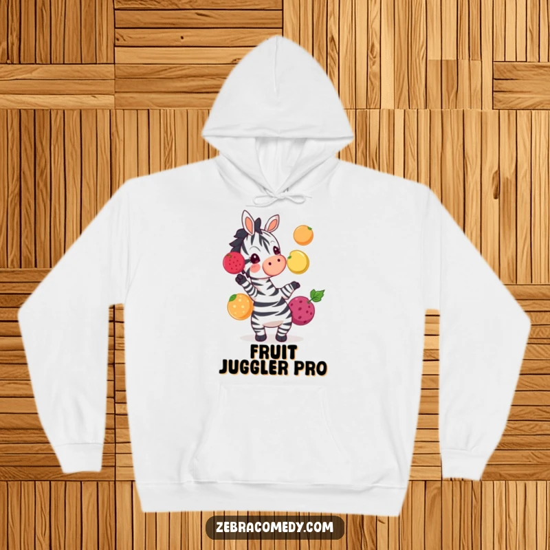 Funny zebra enthusiastically juggling colorful fruits, a warm and amusing hoodie perfect for casual wear.