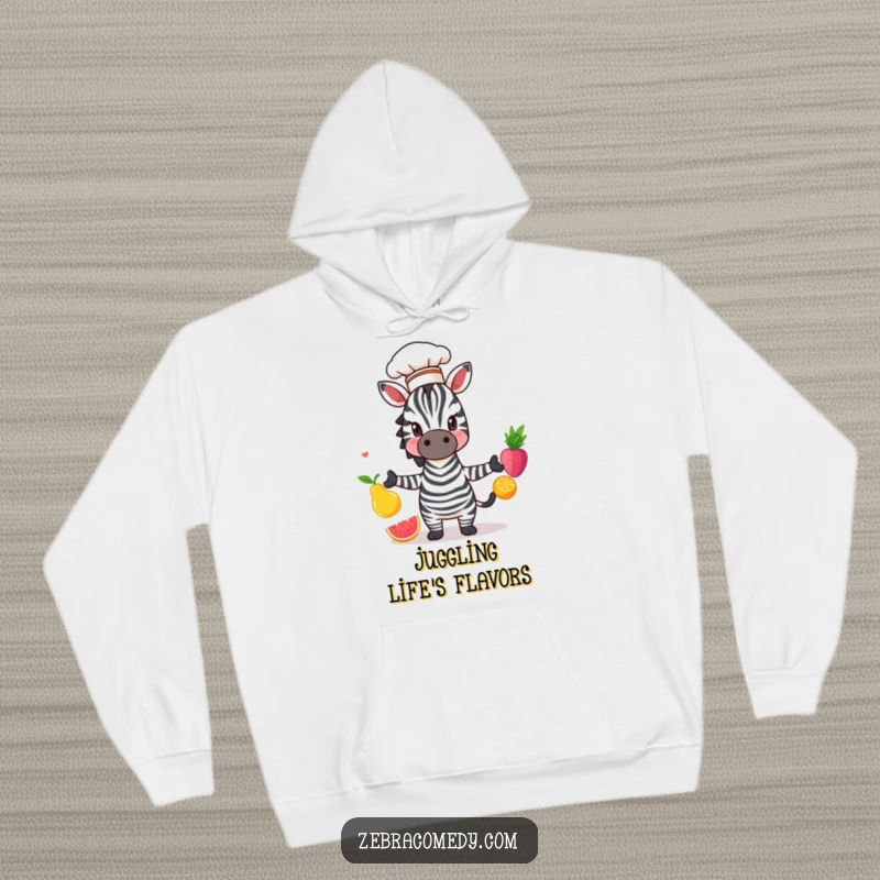 Funny Zebra Hoodie: A comically skilled zebra in a chef hat, juggling fruit with precision and charm, adding humor to comfort.