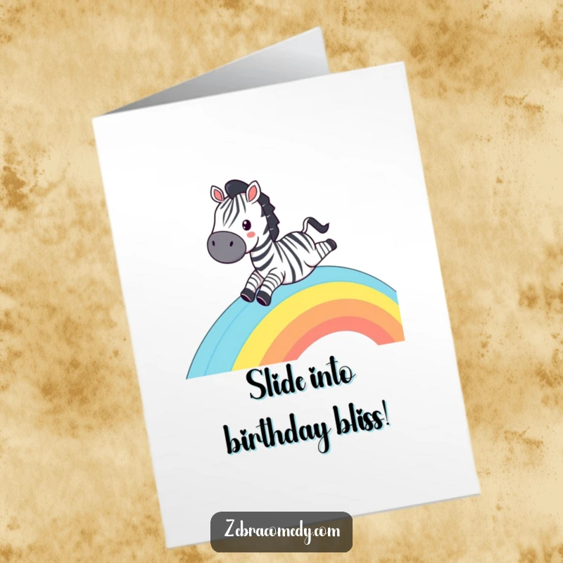 Funny Free Printable Birthday Card: Zebra sliding down a striped rainbow with a massive grin, radiating pure fun.