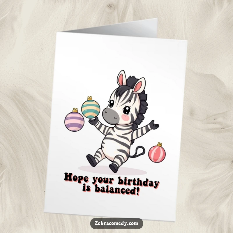 Funny Free Printable Birthday Card: A zebra comically tripping while attempting to juggle three striped baubles, pure chaos.