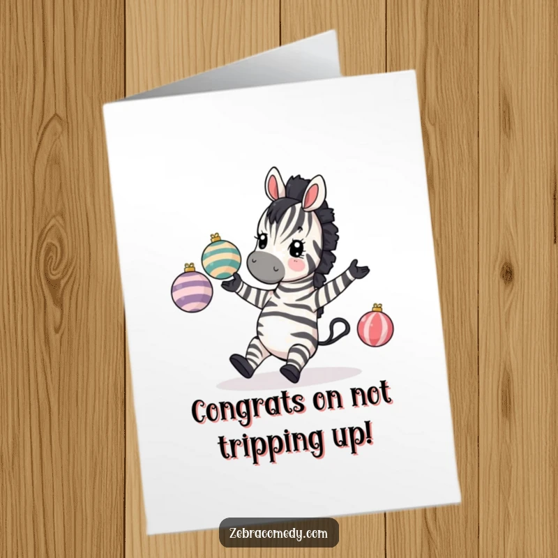 Funny Free Printable Congratulations Card: A zebra comically tripping, dropping striped baubles while juggling, a hilarious moment.